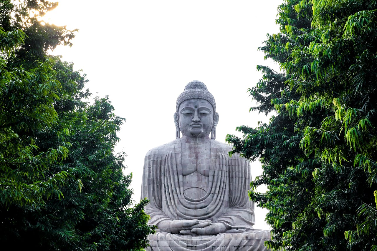Great Buddha statue surrounded by lush trees in Bodh Gaya, India. Serene and iconic landmark.